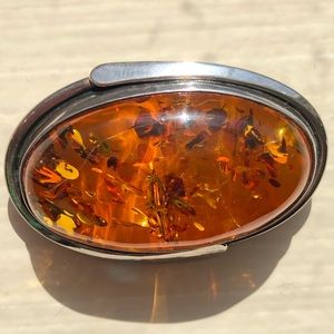 Amber oval set in silver brooch, measuring just over 1.5” wide by 1” high